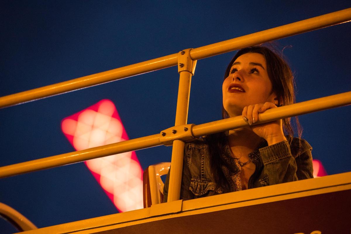 a woman is looking up through a metal pole