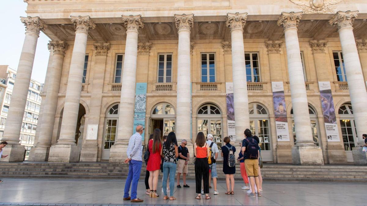 a group of people standing in front of a building