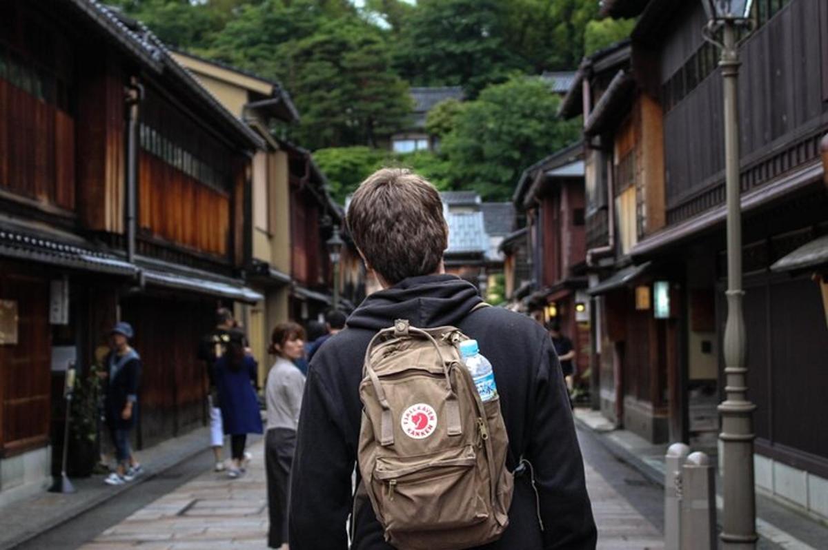 a man with a backpack walking down a street