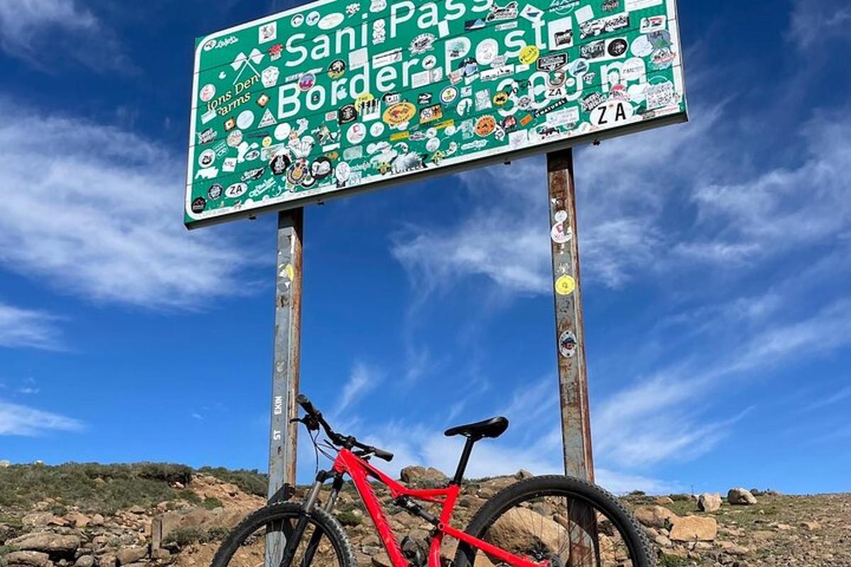 a sign with a red bike parked next to it