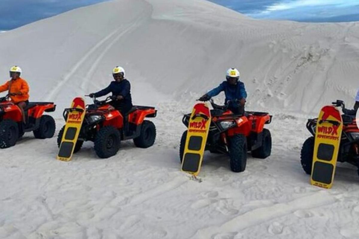 a group of people riding on atvs in the snow