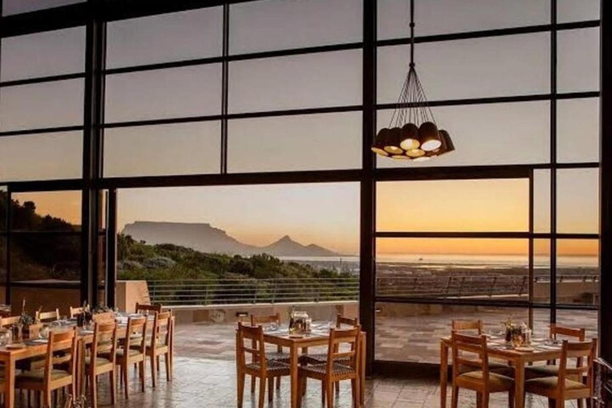 a dining room with tables and chairs and a large window