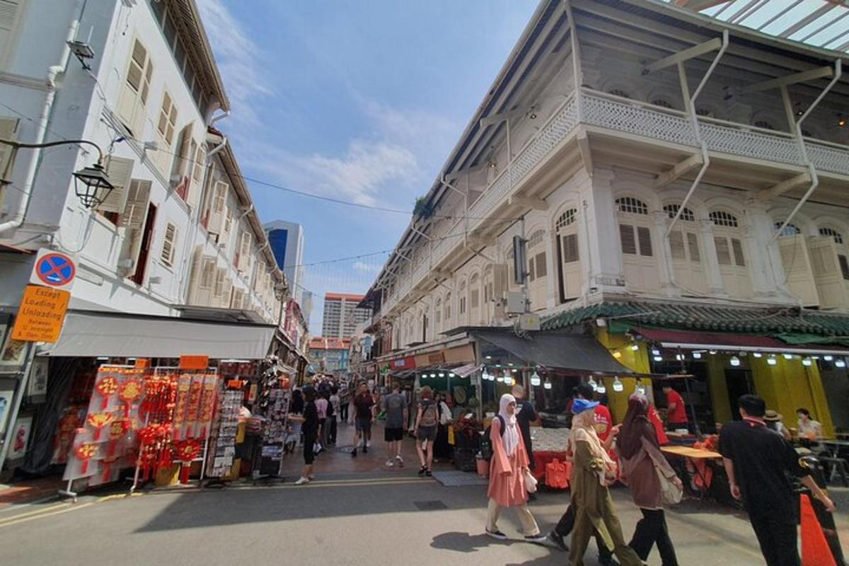 a group of people walking through a street market