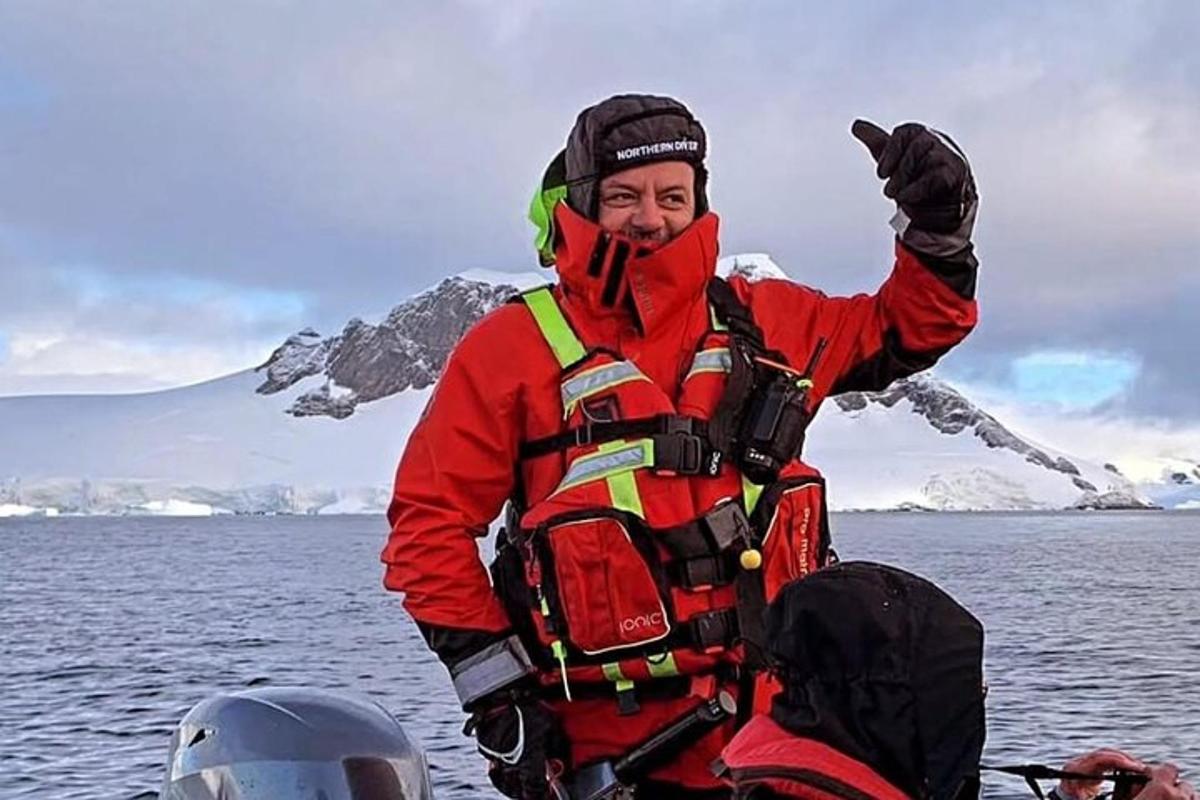 a man in a life vest on a boat in the water