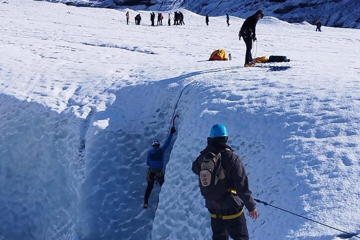 a group of people standing on top of a mound of snow
