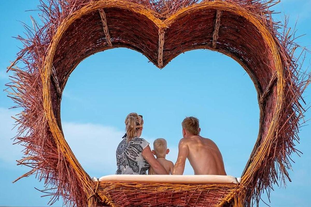 a family sitting in a heart shaped wicker basket