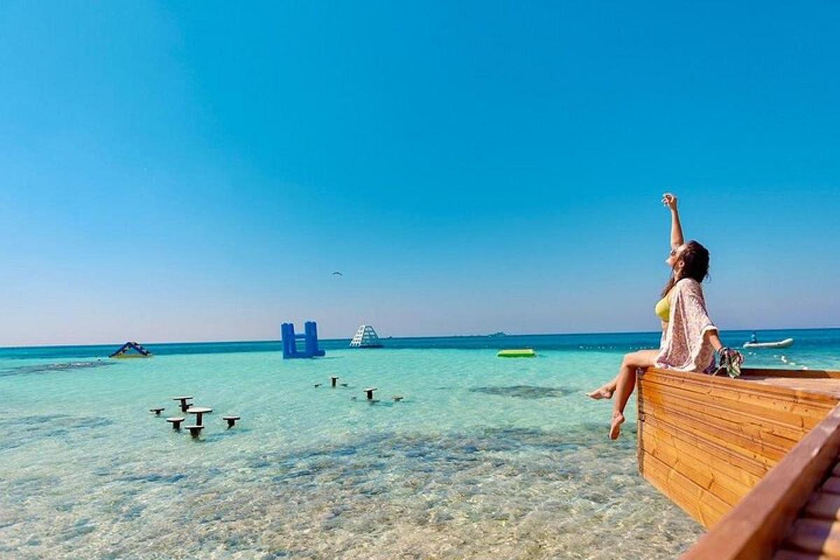 a woman sitting on a dock on the beach