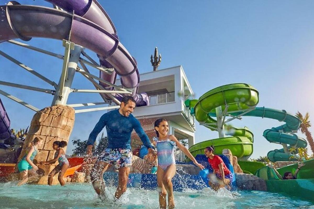 a group of people in the water at a water park