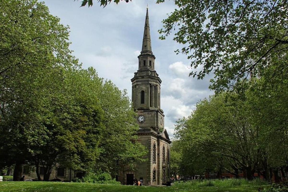 a tall building with a clock tower in a park