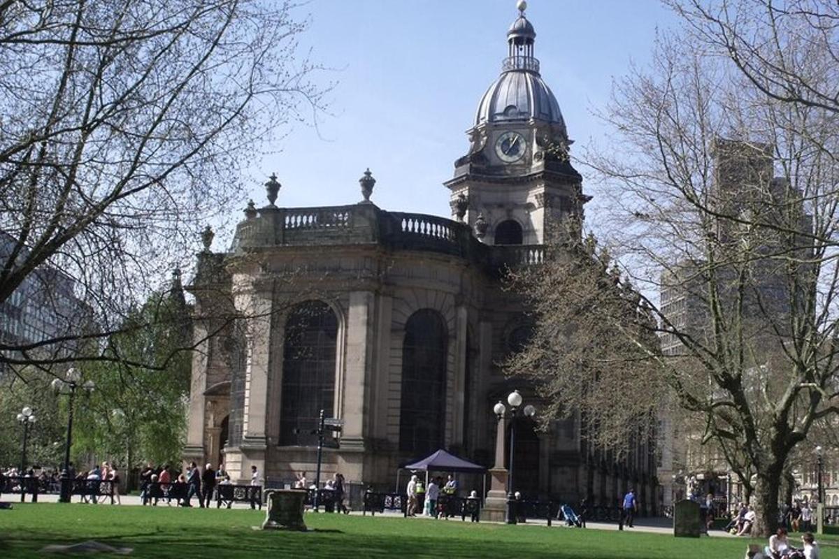 a large building with a clock tower in a park