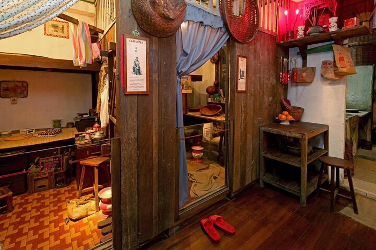 a room with a kitchen with a mirror and red shoes