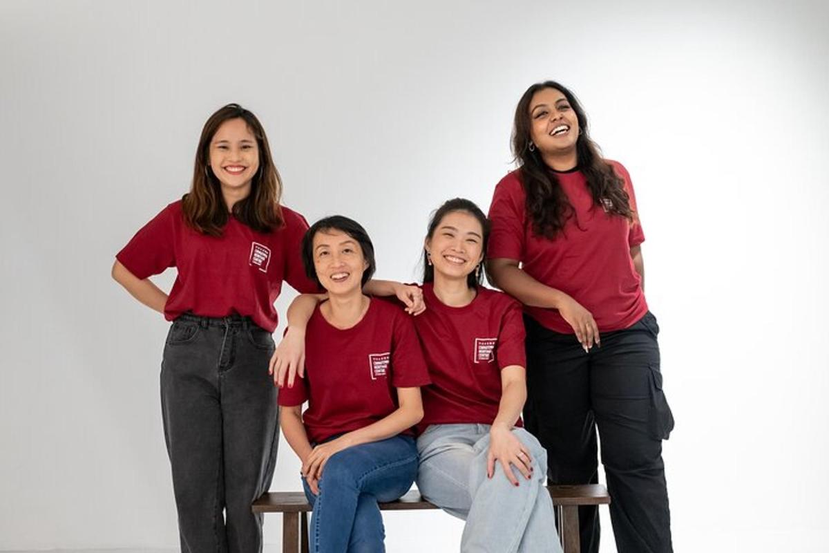 a group of girls in red shirts sitting on a bench