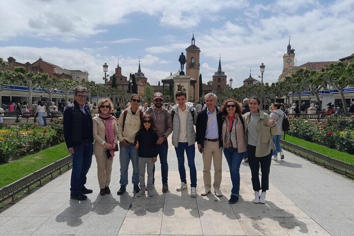a group of people posing for a picture in front of a building