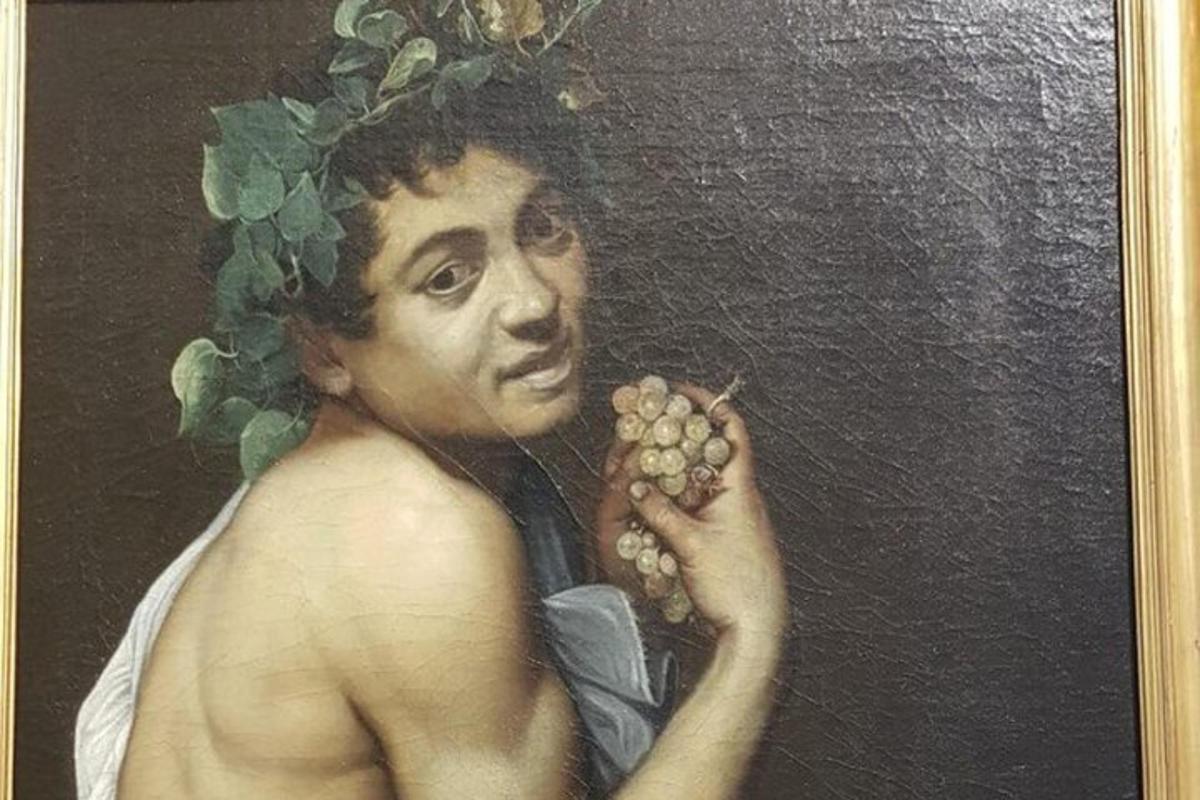 a painting of a man holding a bunch of grapes