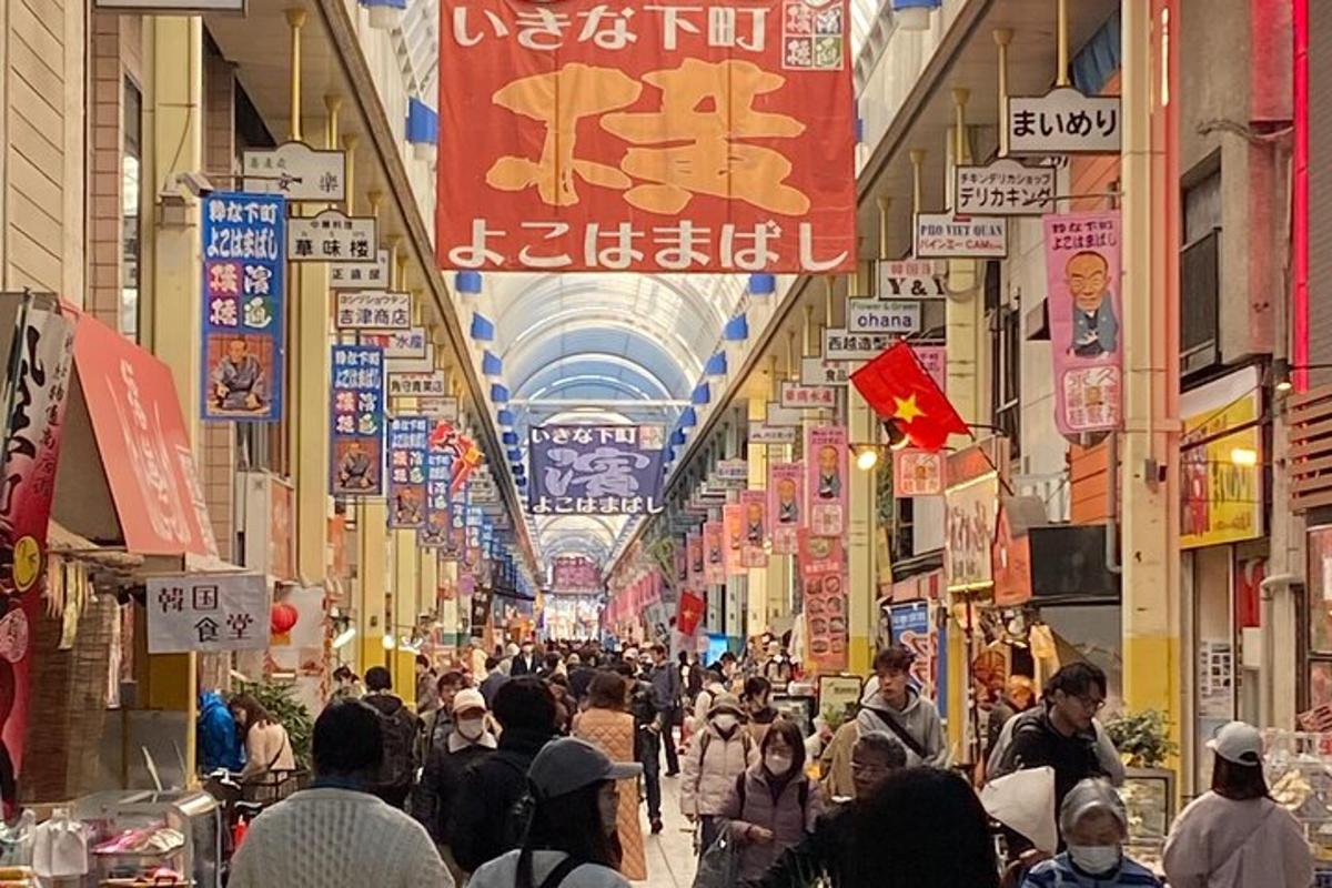 a crowd of people walking through a shopping mall