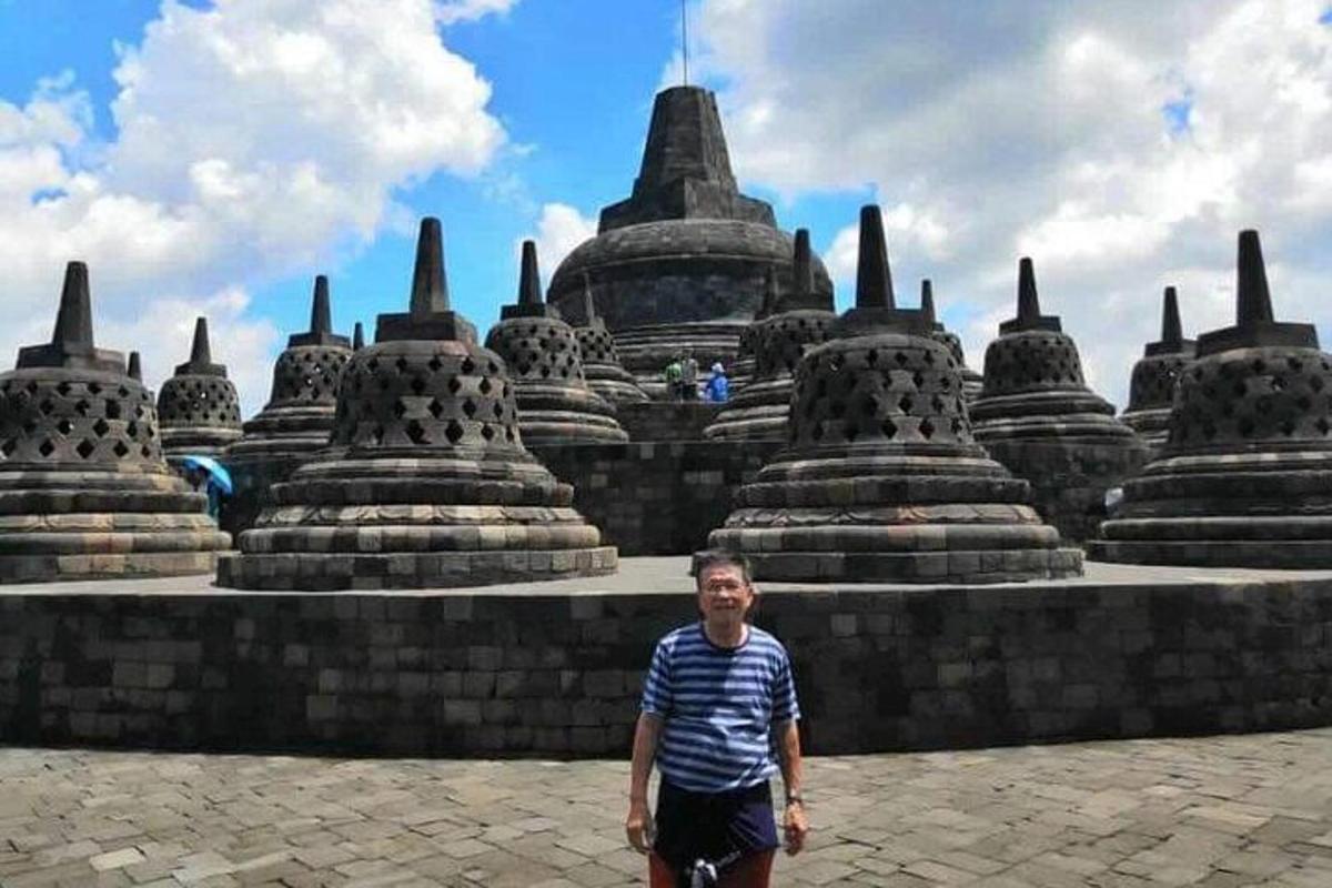 a man standing in front of a large building