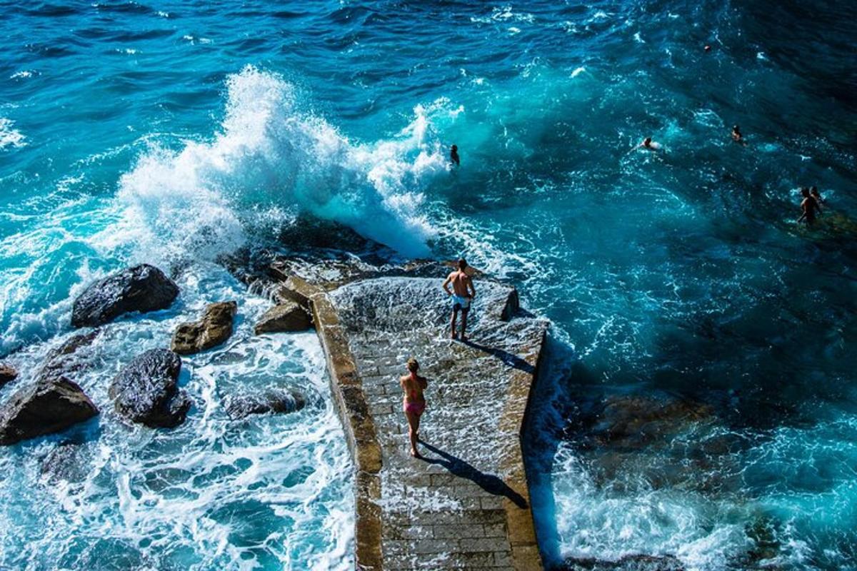 un gruppo di persone in piedi su un molo nell'oceano