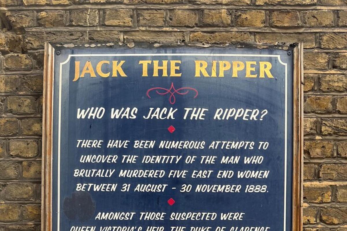 a sign on the side of a brick wall