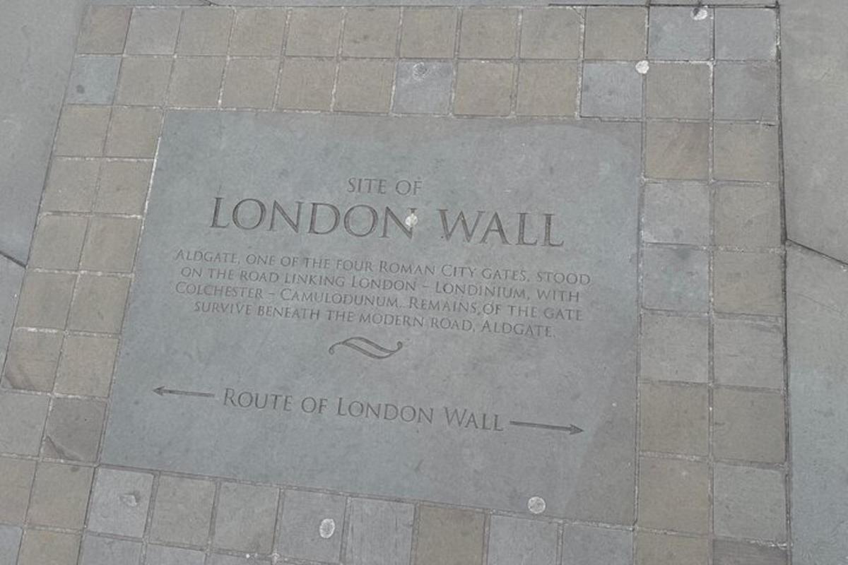 a sign on the ground on a brick sidewalk