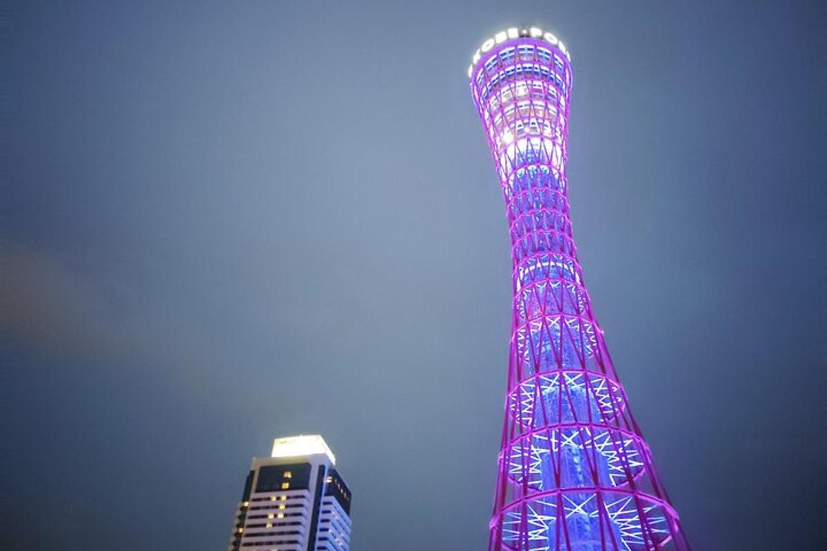 a tall tower lit up in pink and blue