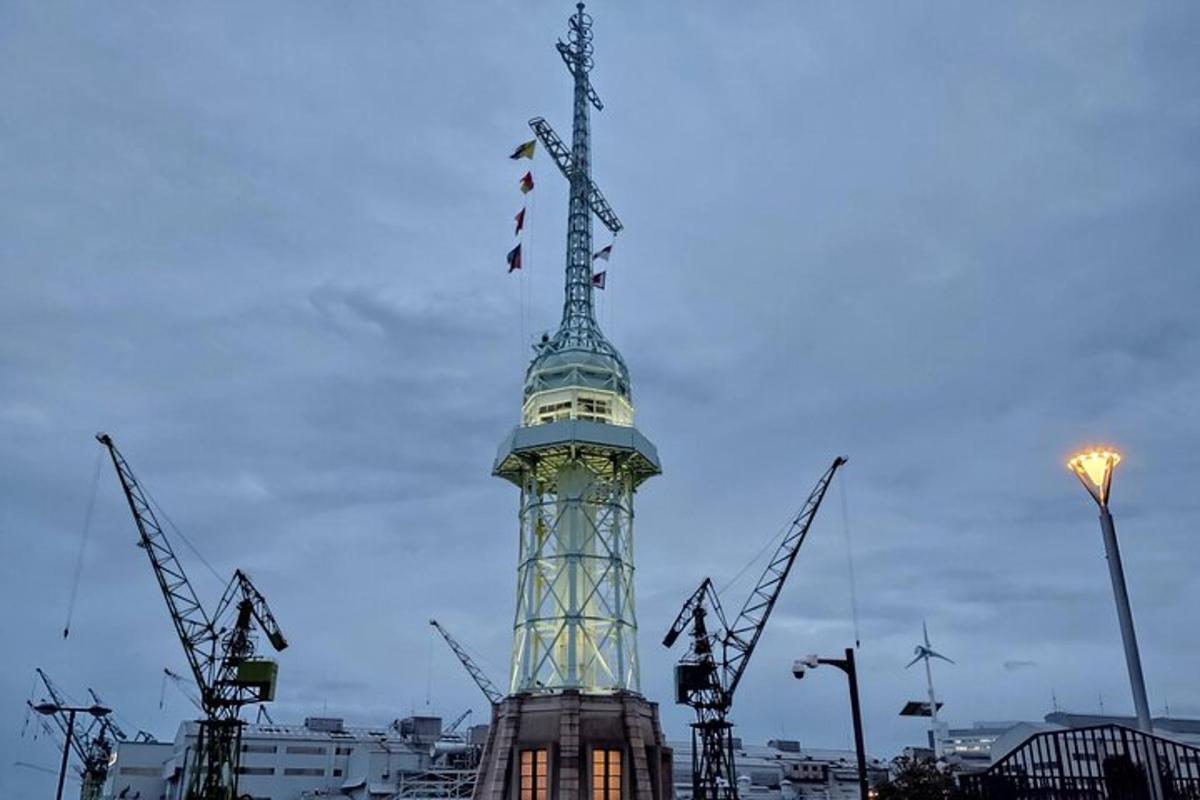 a tall tower with flags on top of it