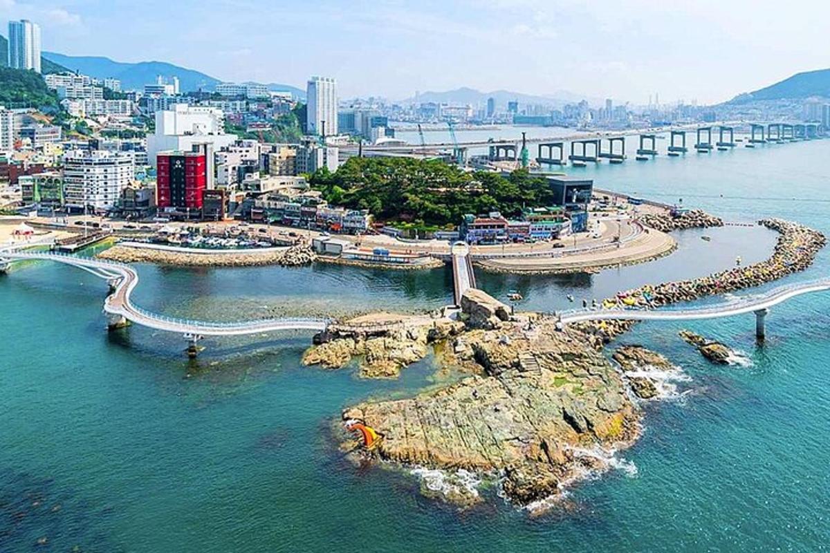 an aerial view of a city with a bridge over the water