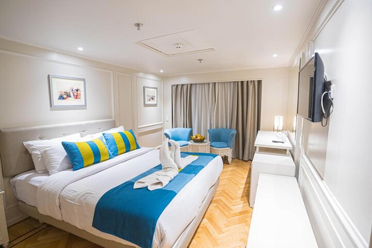 a hotel room with a large bed and a television