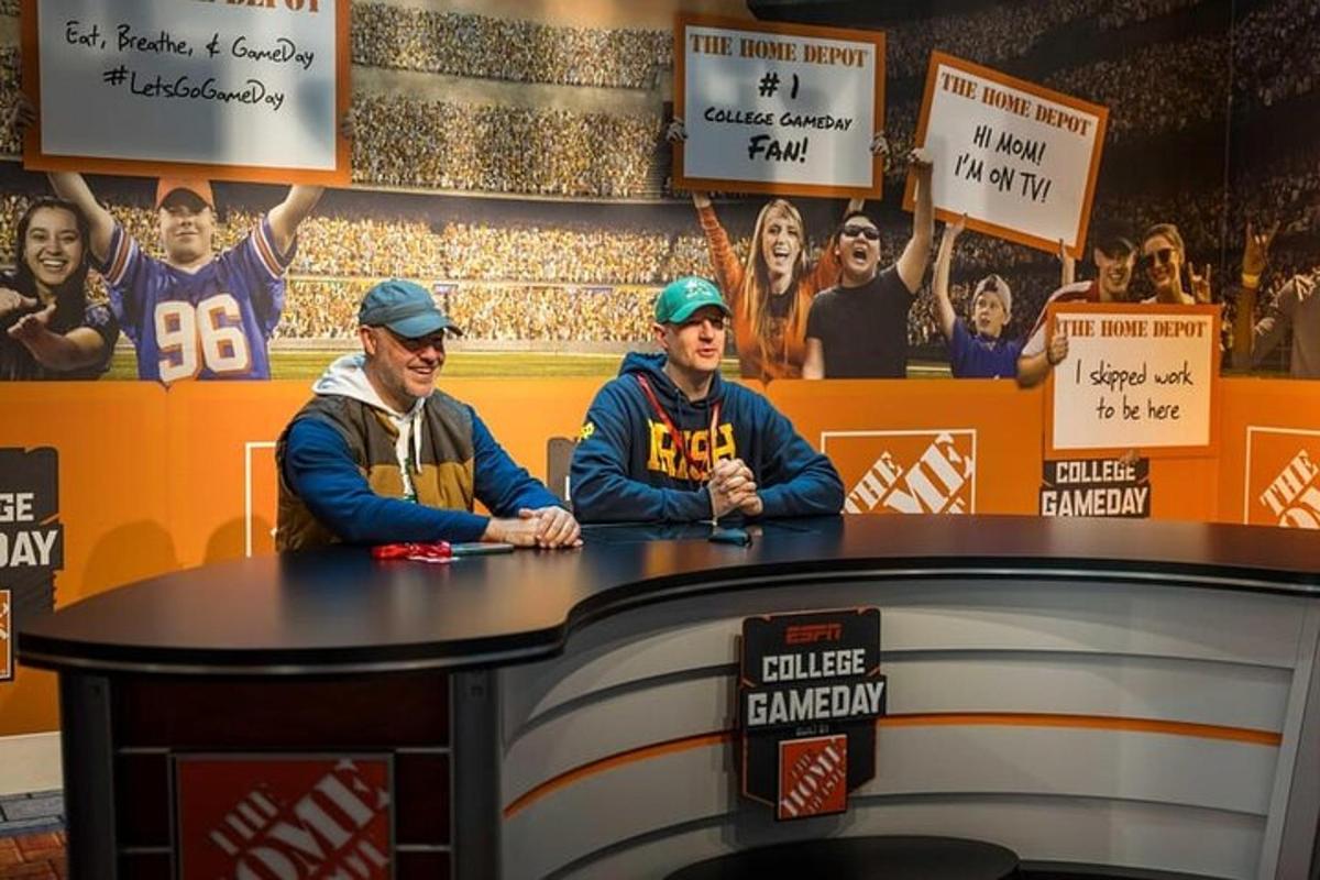 two men sitting at a table with signs