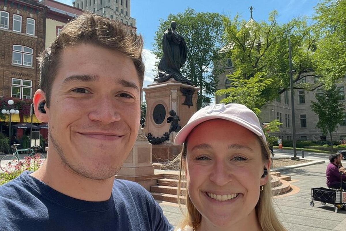 a man and a woman standing in front of a statue
