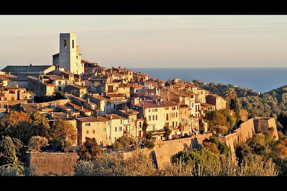a village on top of a hill with a clock tower