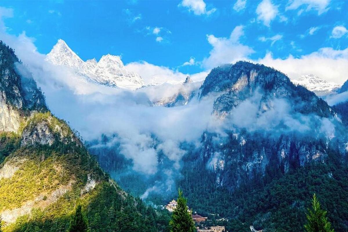 a view of a mountain range with snow capped mountains