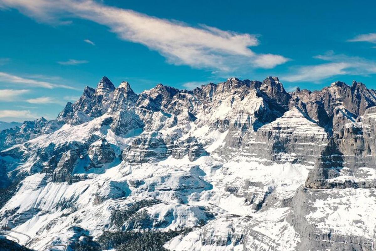 a large snowy mountain range with a blue sky