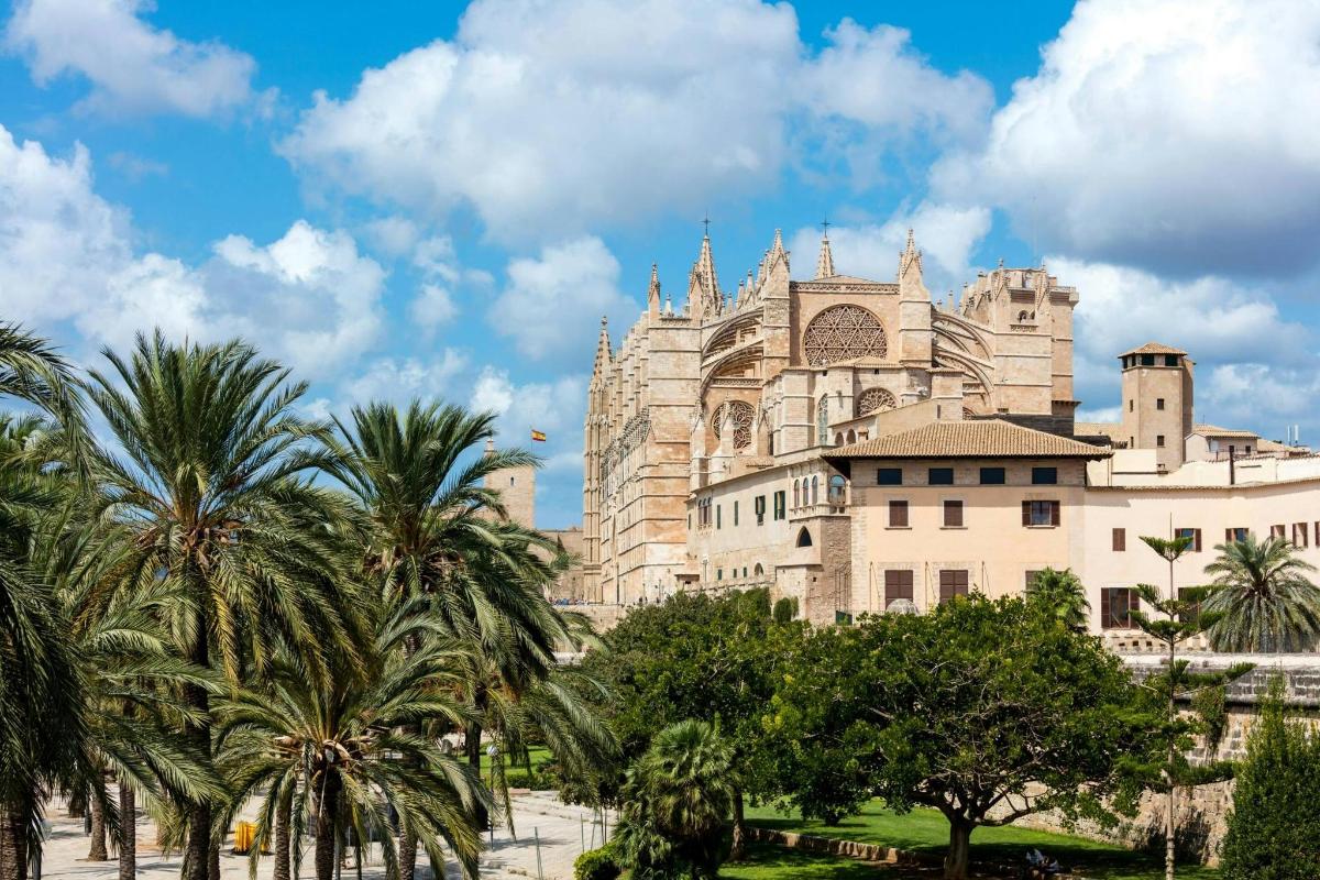 a large building with palm trees in front of it