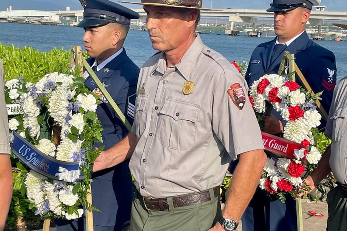 a man in uniform standing next to two police officers