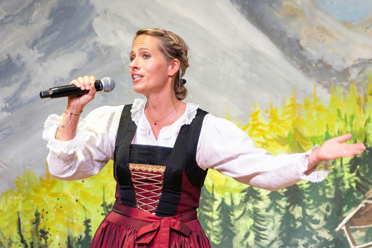 a woman is singing into a microphone