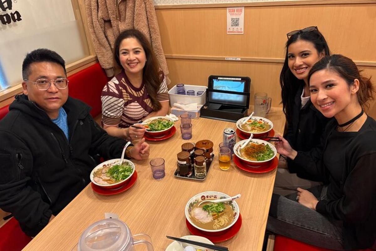 a group of people sitting at a table eating food