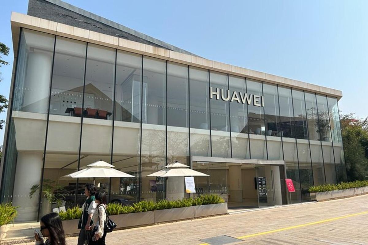 a large building with people walking in front of it