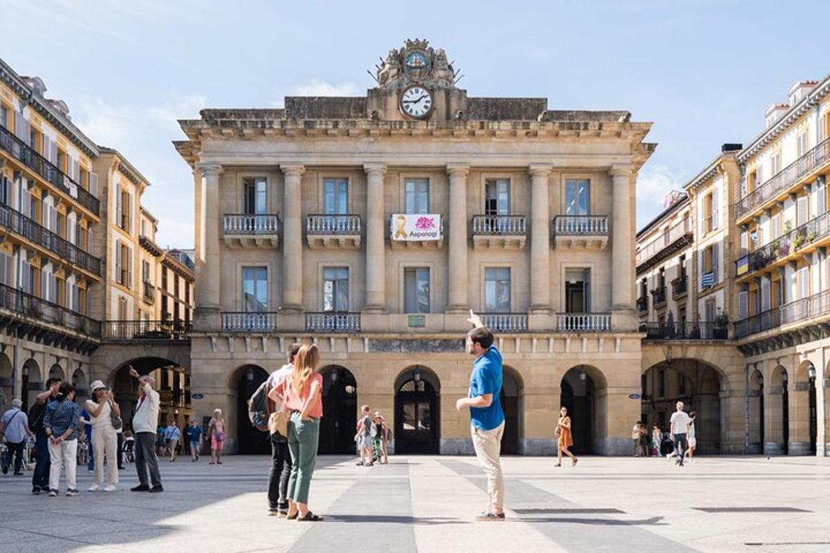 a group of people standing in front of a building with a clock tower