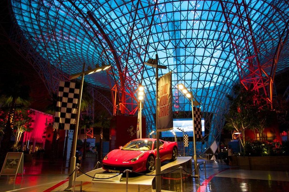 a red car is on display in a building