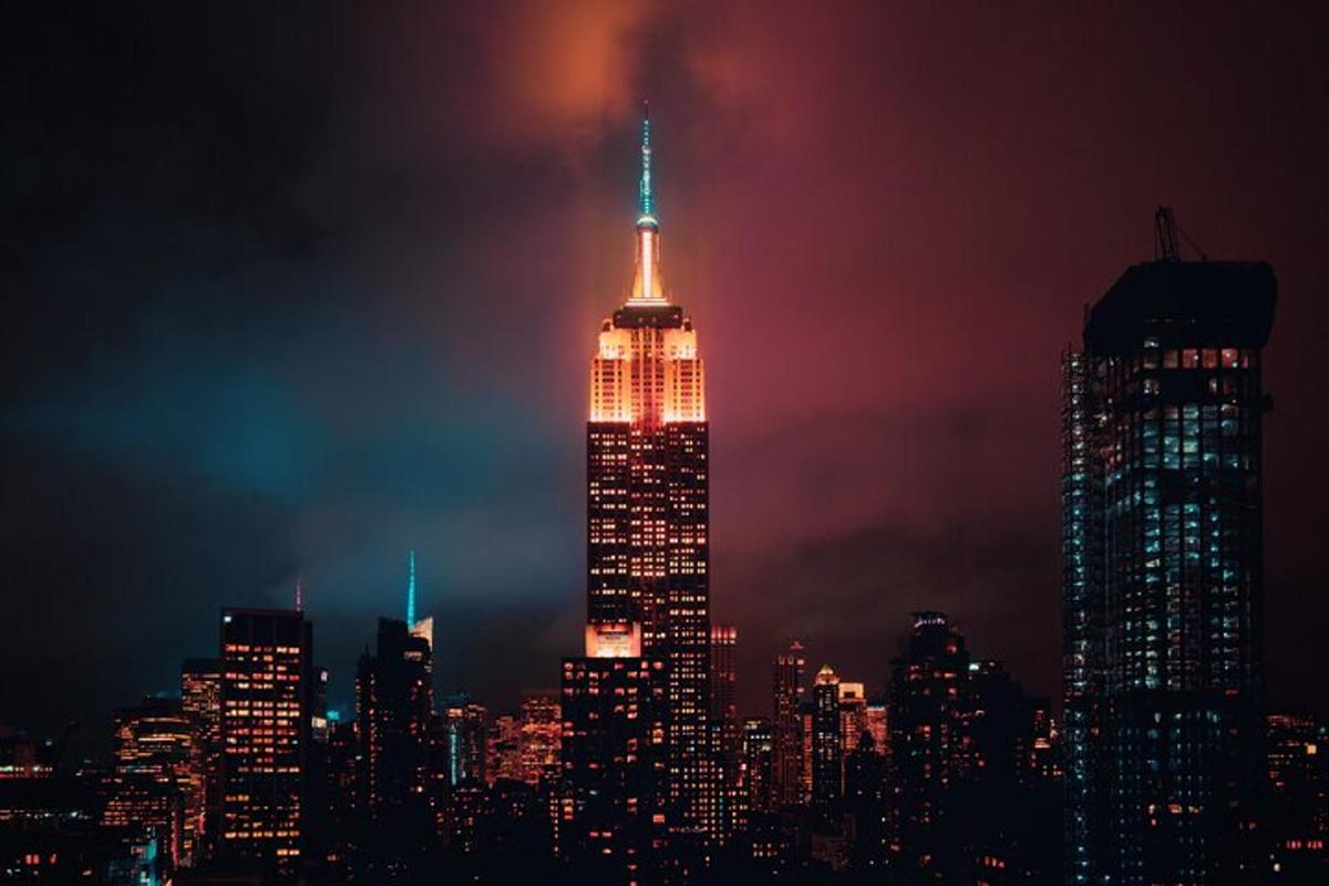 a tall building lit up in red white and blue