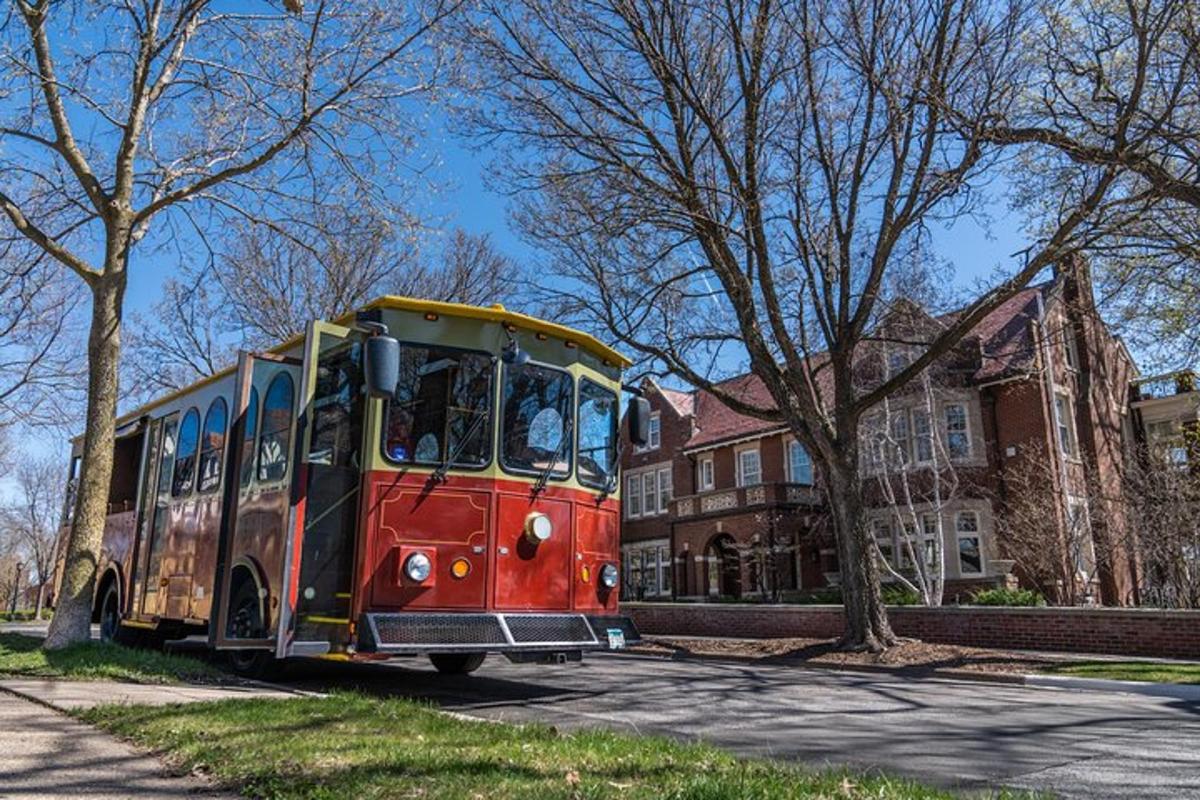 a red and yellow bus driving down a street