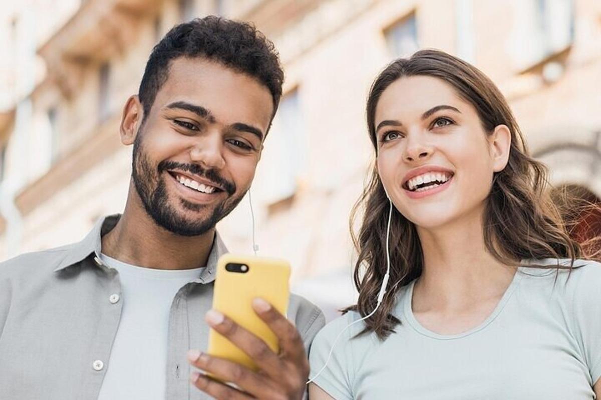 a man and a woman looking at a cell phone