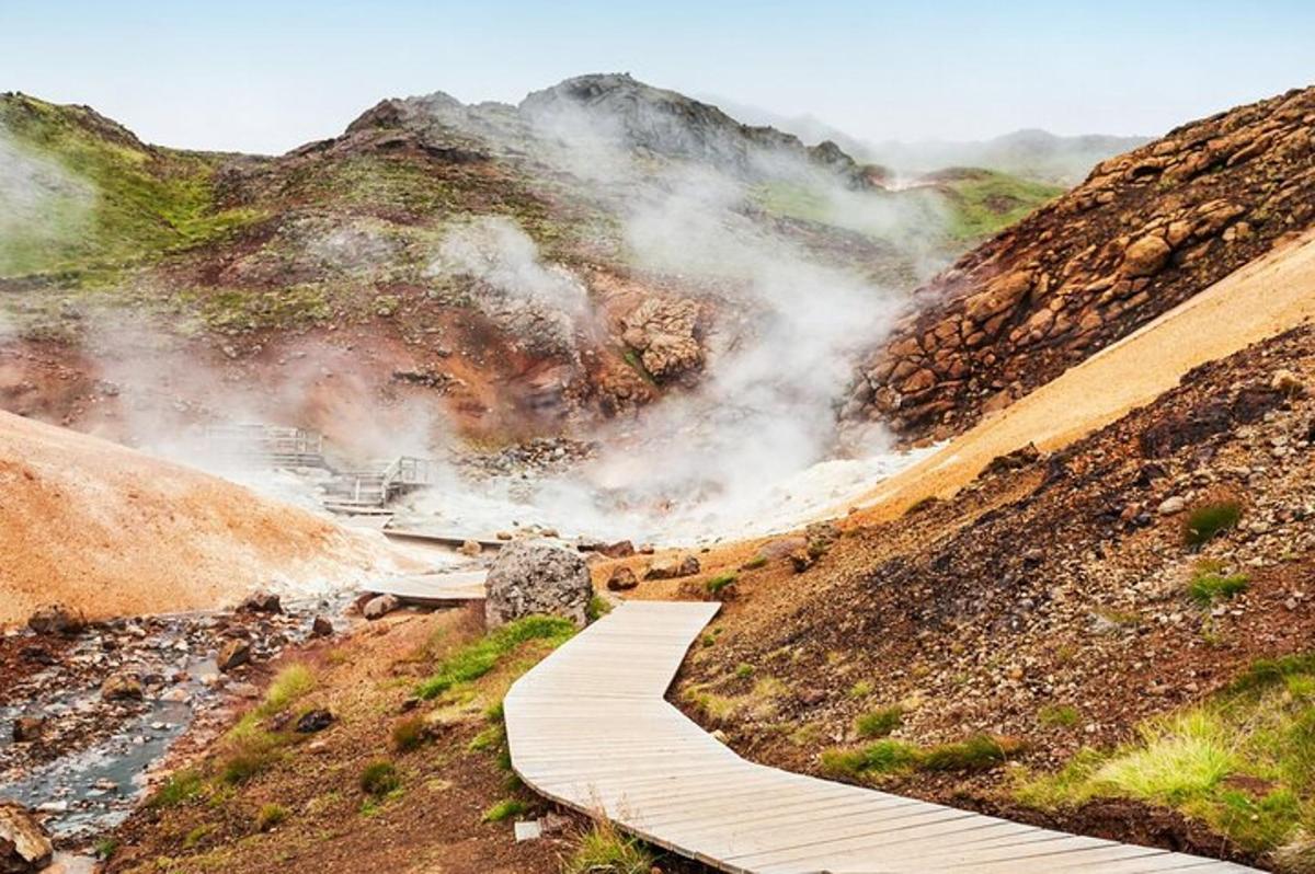 a wooden boardwalk on a mountain with a river