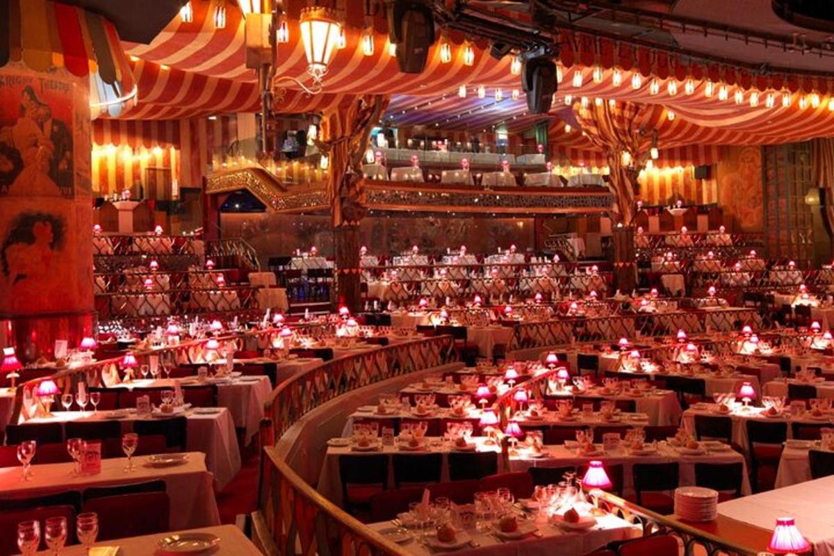a large dining room with white tables and chairs
