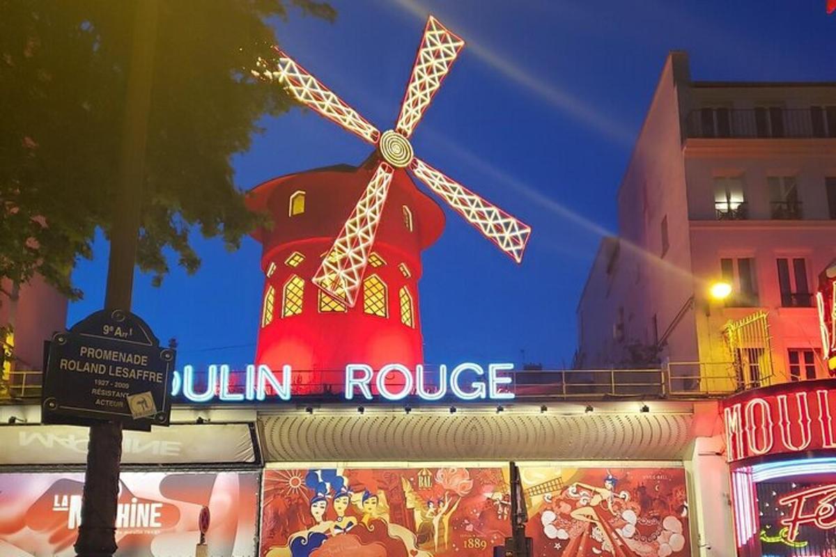 a sign with a windmill on top of a building