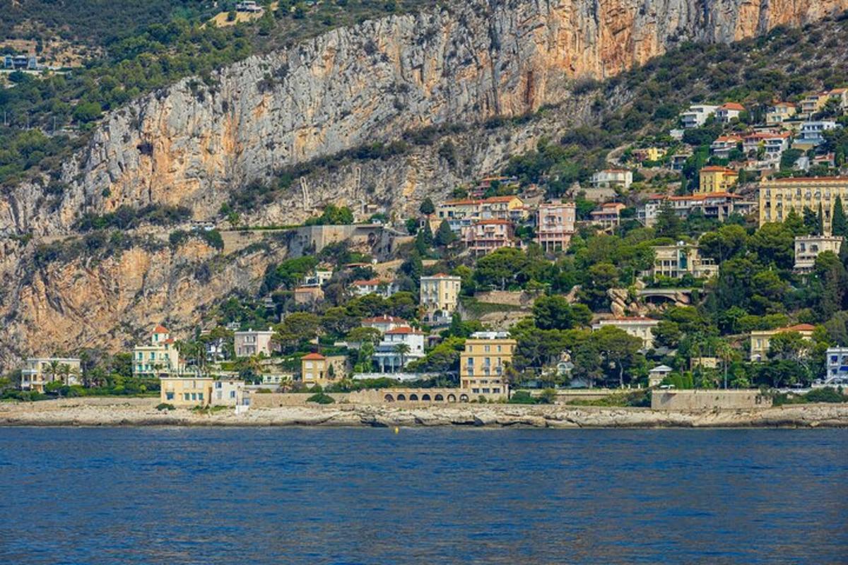 a town on the side of a mountain next to the water