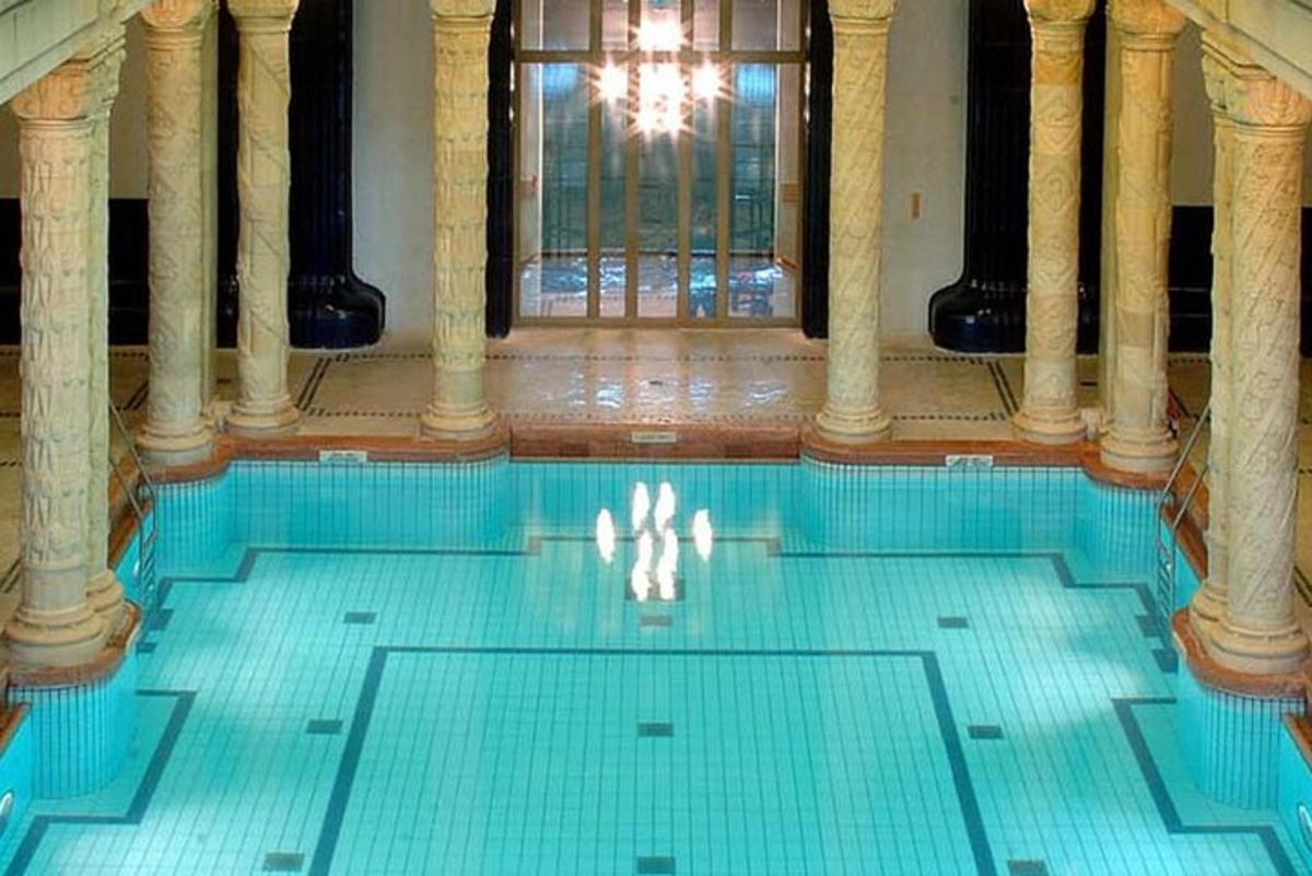 a swimming pool with a chandelier in a building
