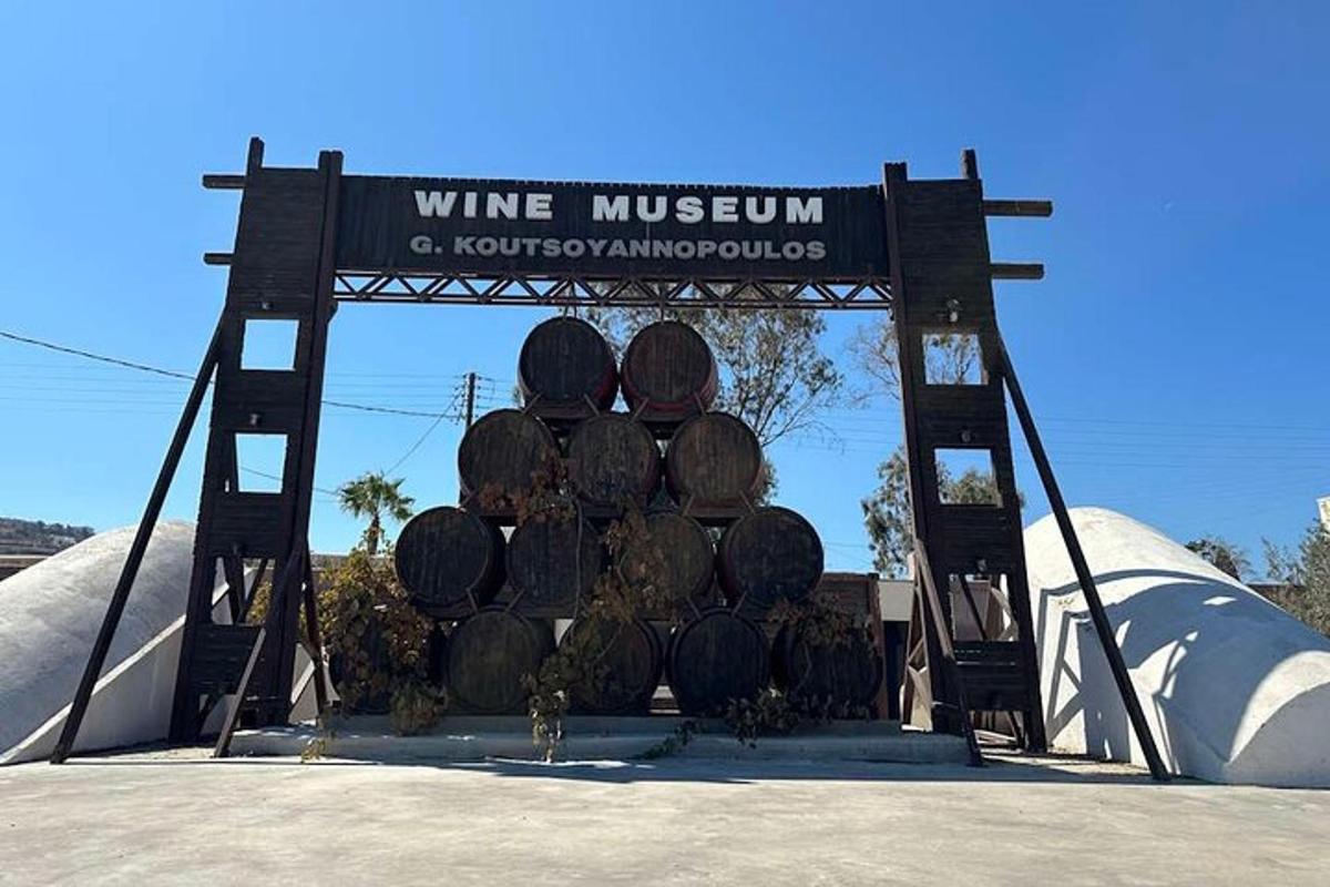 a sign for a wine museum with barrels