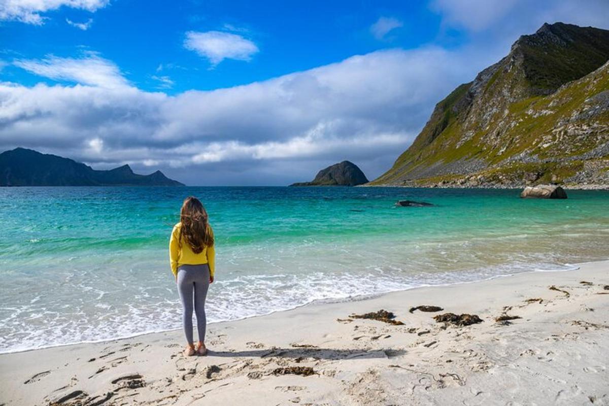 a woman standing on a beach near the ocean