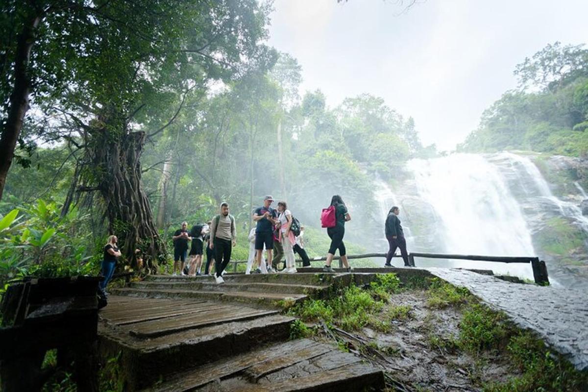 sekelompok orang berjalan di tangga di depan air terjun